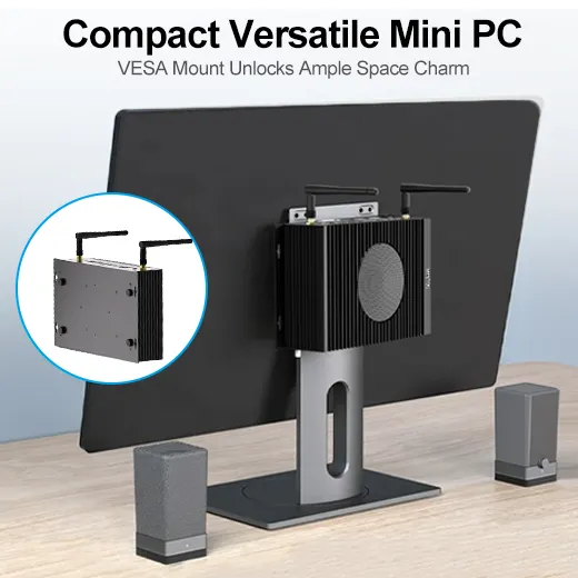 HYSTOU H6 Fan mini PC mounted on the back of a monitor to save desk space, featuring antennas and desktop speakers in a clean workspace setup